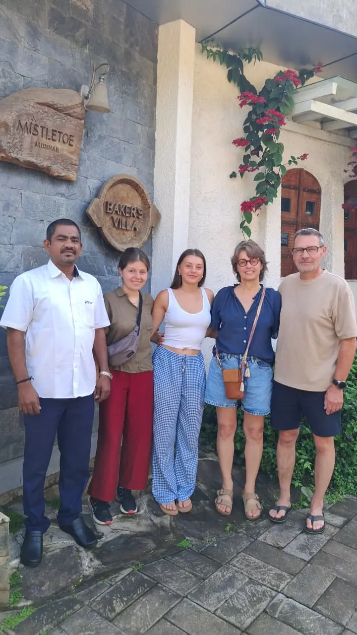 Our driver with four overseas guests outside a heritage villa during a South India tour