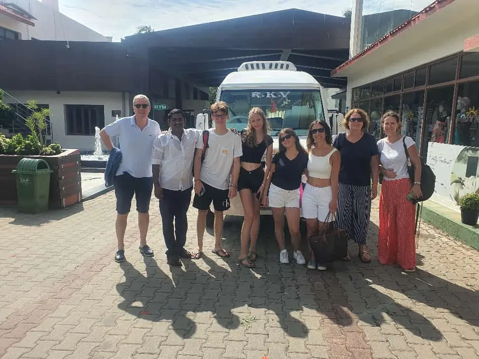 Overseas group with our driver outside a resort building