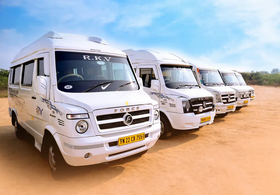Five RKV tempo travellers lined up in a row under a blue sky