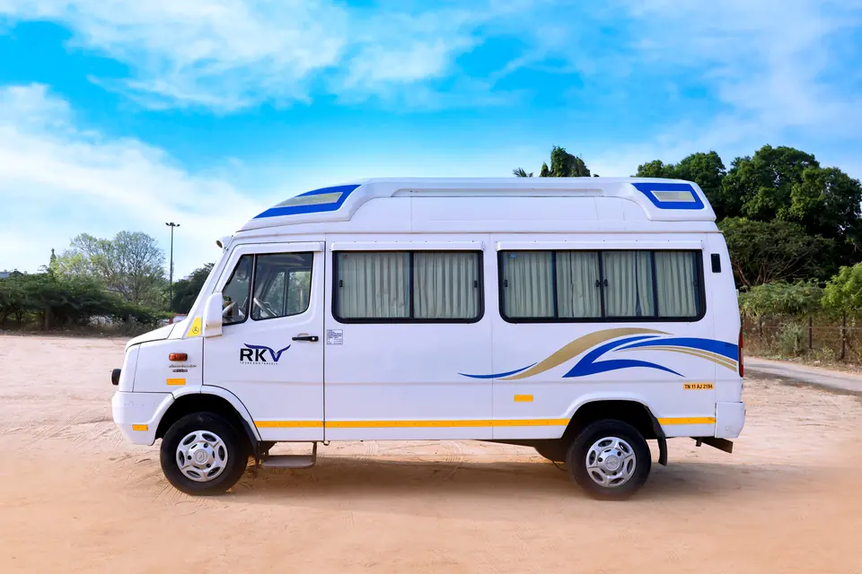 Side profile of an RKV tempo traveller showing large tinted windows and passenger door