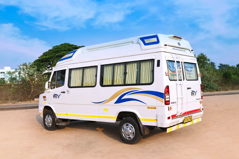 Rear three-quarter view of an RKV tempo traveller with ladder and rear luggage door