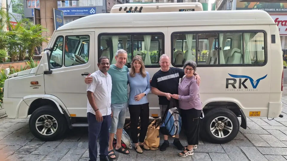 Four overseas guests and our driver in front of an RKV tempo traveller on a city street